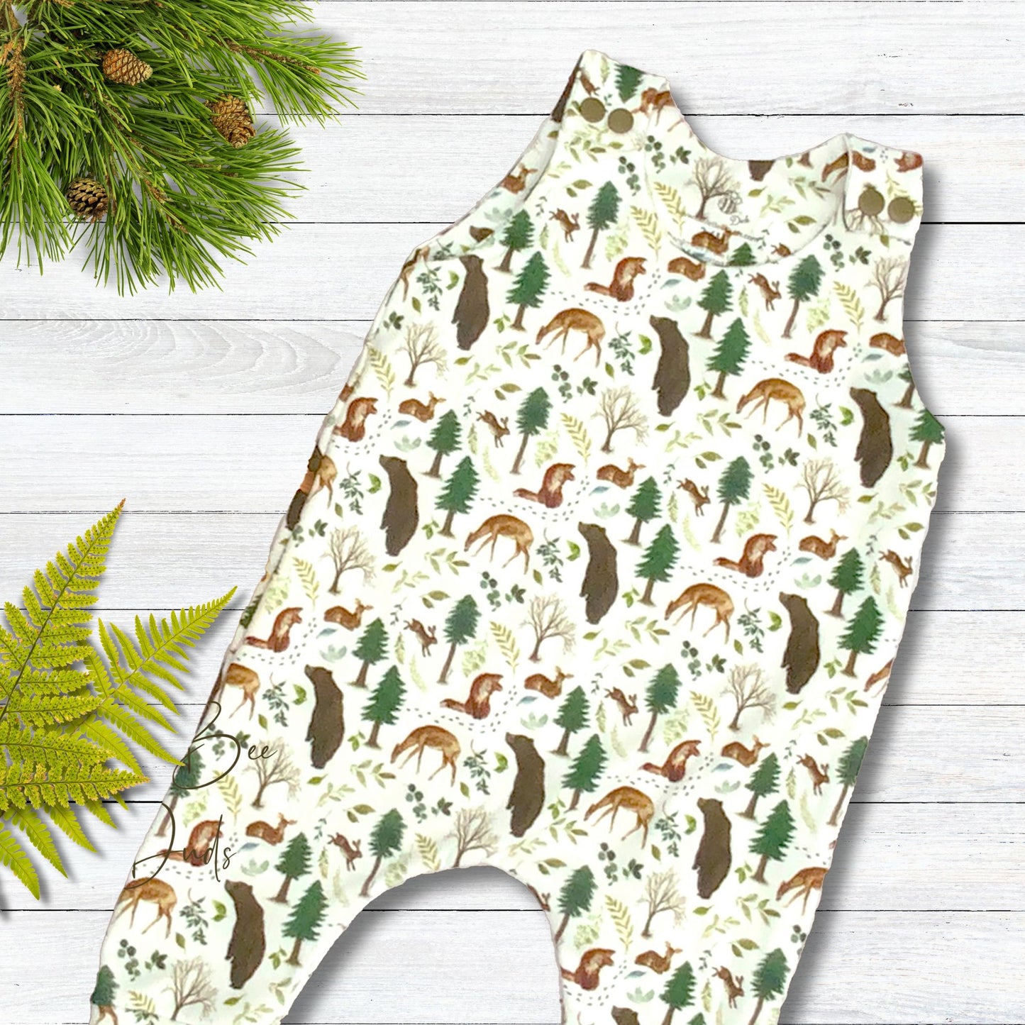 Fun forest wildlife print with deer, bears and more on a white background. Long romper in organic cotton with matching shoulder snaps