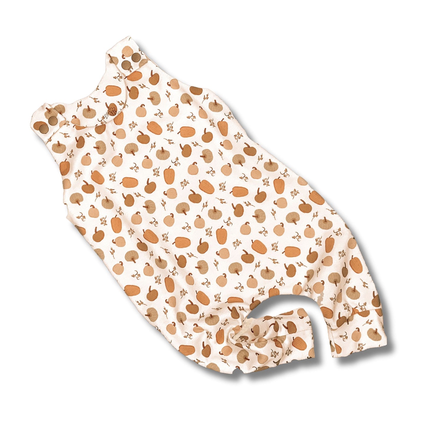 Long romper with a cute pumpkin print in different shades on a white backgroun. Snaps at the shoulder to match