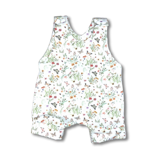 Pretty short romper with butterflies and wildflowers on a white backgrouond.