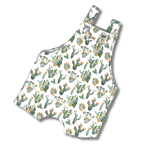 Cute cactus print short knotted romper for baby and toddlers.  Shades of green on a white background