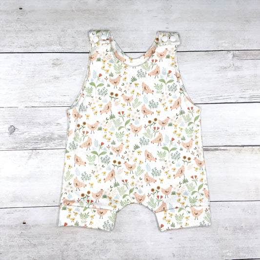 Summer short romper with country theme chicken print with flowers and plants on a white background