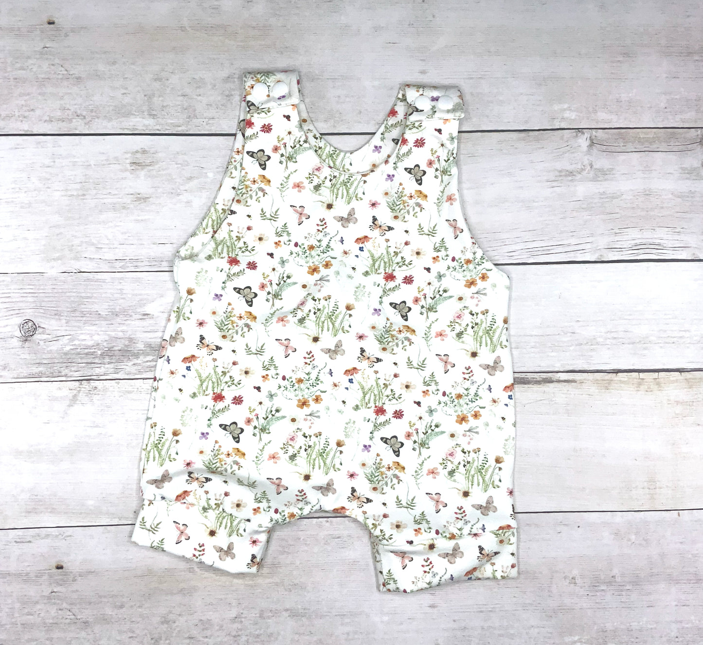 Summer short romper for baby and toddler girls with a flower and butterfly print