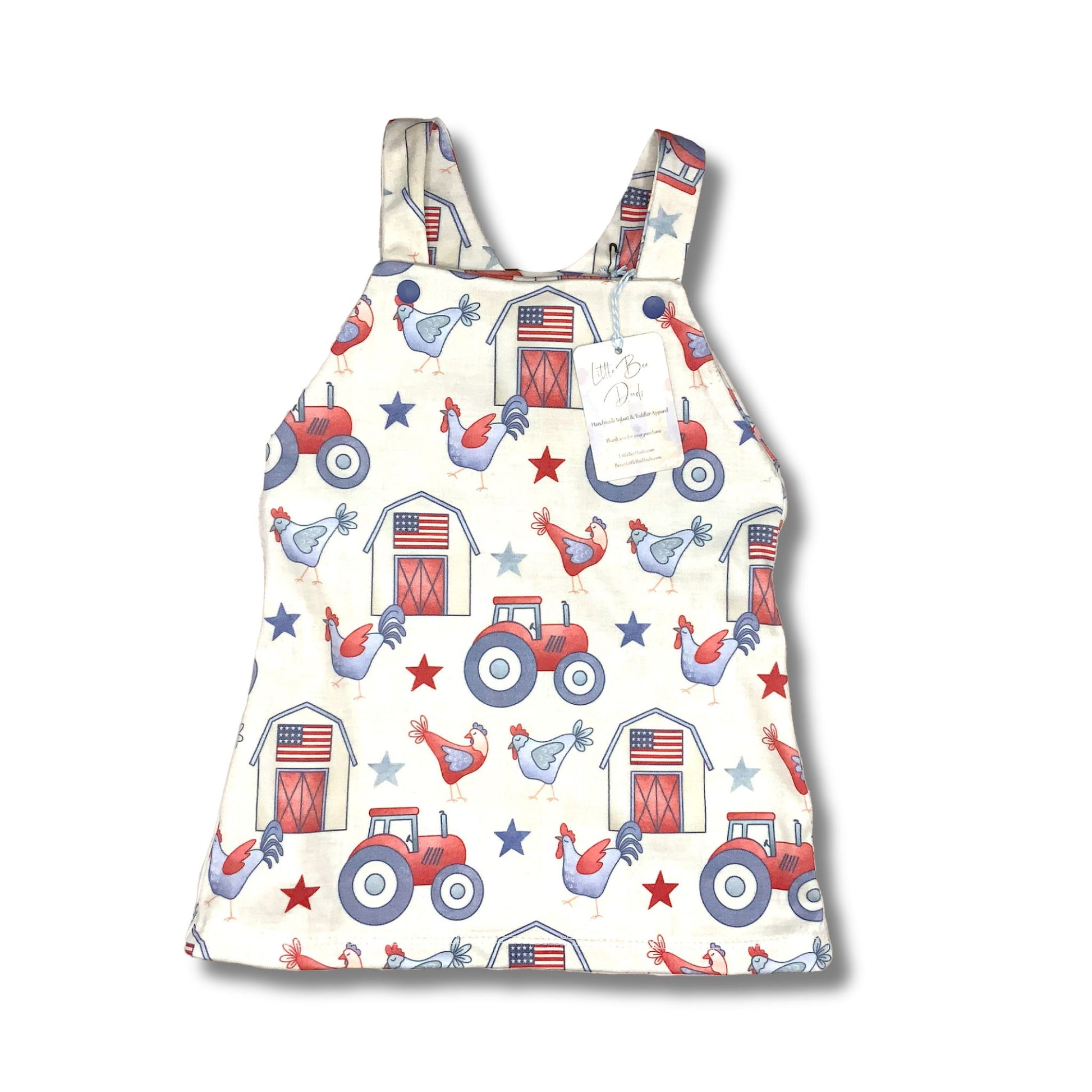 Jumper style dress for baby and toddler girls.  Red, white and blue farm theme with varm, tractor and chickens on a cream background