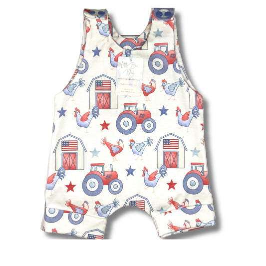 Short romper with red, white and blue patriotic farm themed print. Tractors, chickens with a barn with an American Flag