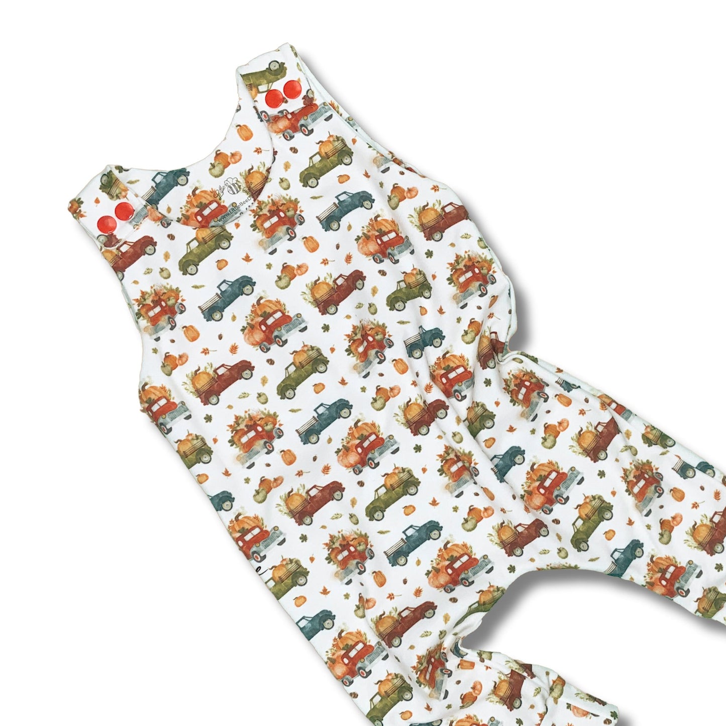 Long romper with a fall theme.  Vintage trucks loaded with pumpkins on a white background